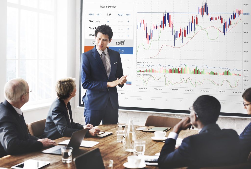 Business team analyzing financial data, showcasing Grand Cayman services.
