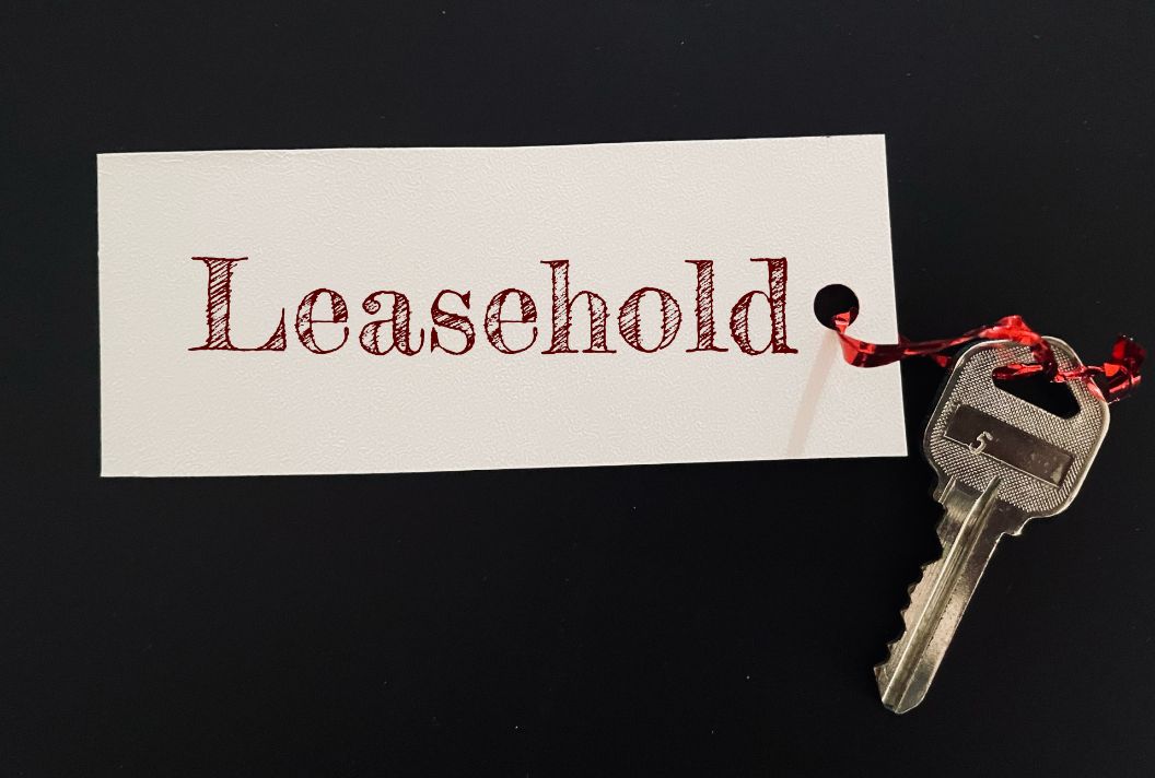 a paper written leasehold on it, isolated on a black background