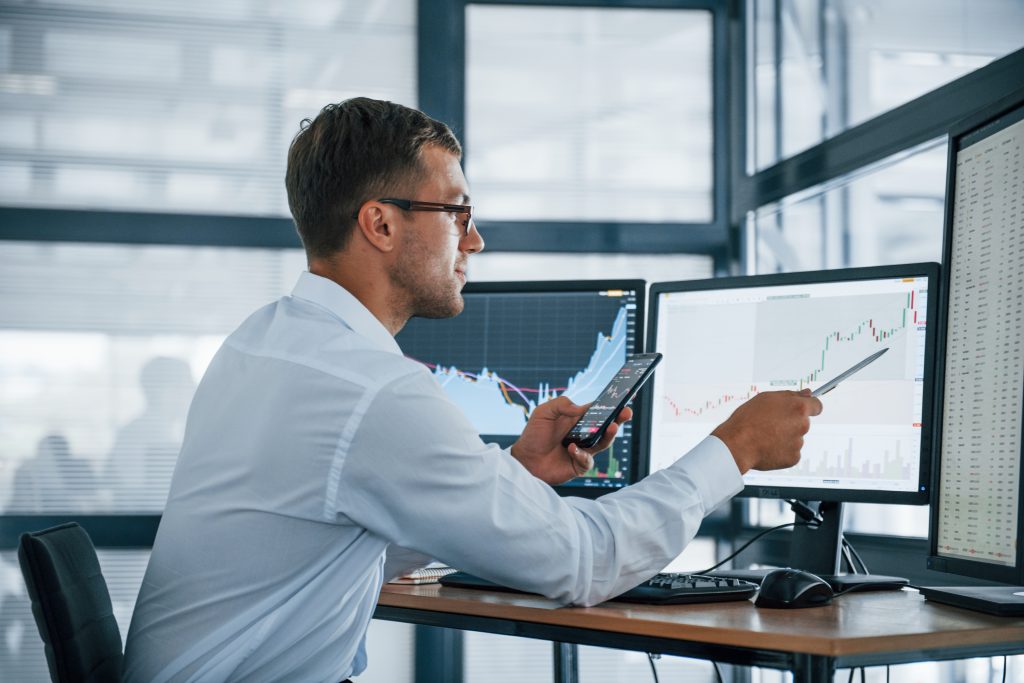 an investment manager analyzing graphs for Grand Cayman Services