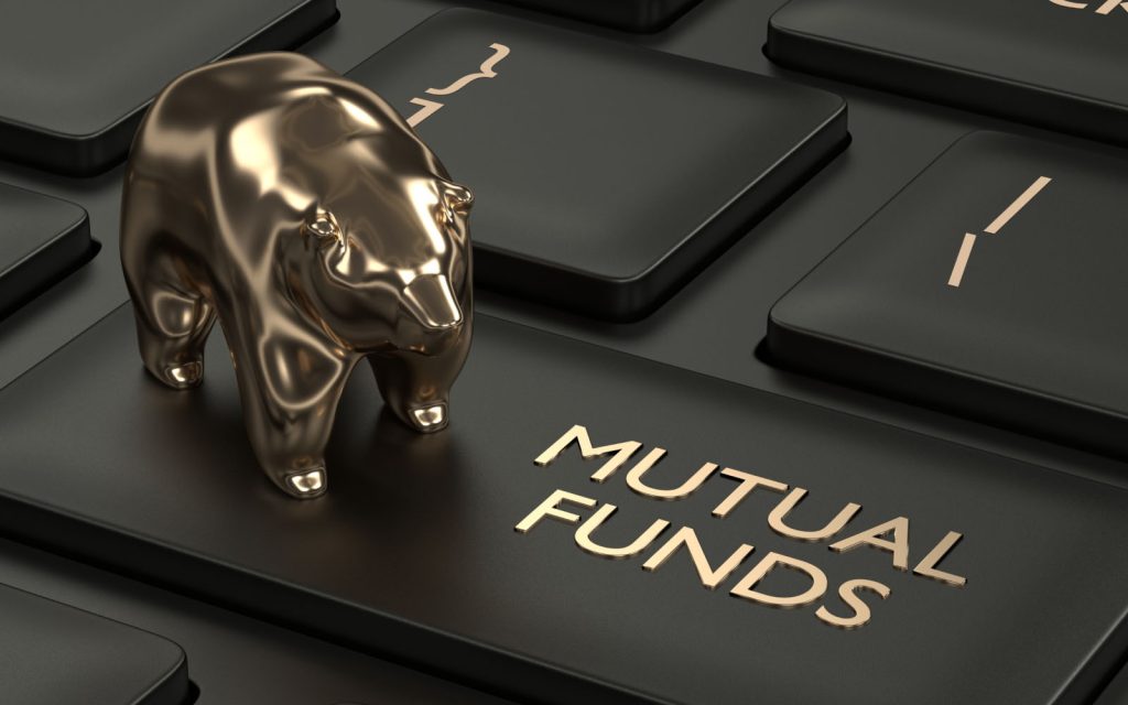 Golden bear on keyboard key labeled Mutual Funds, symbolizing investing
